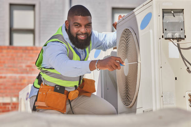HVAC technician working on outdoor AC unit